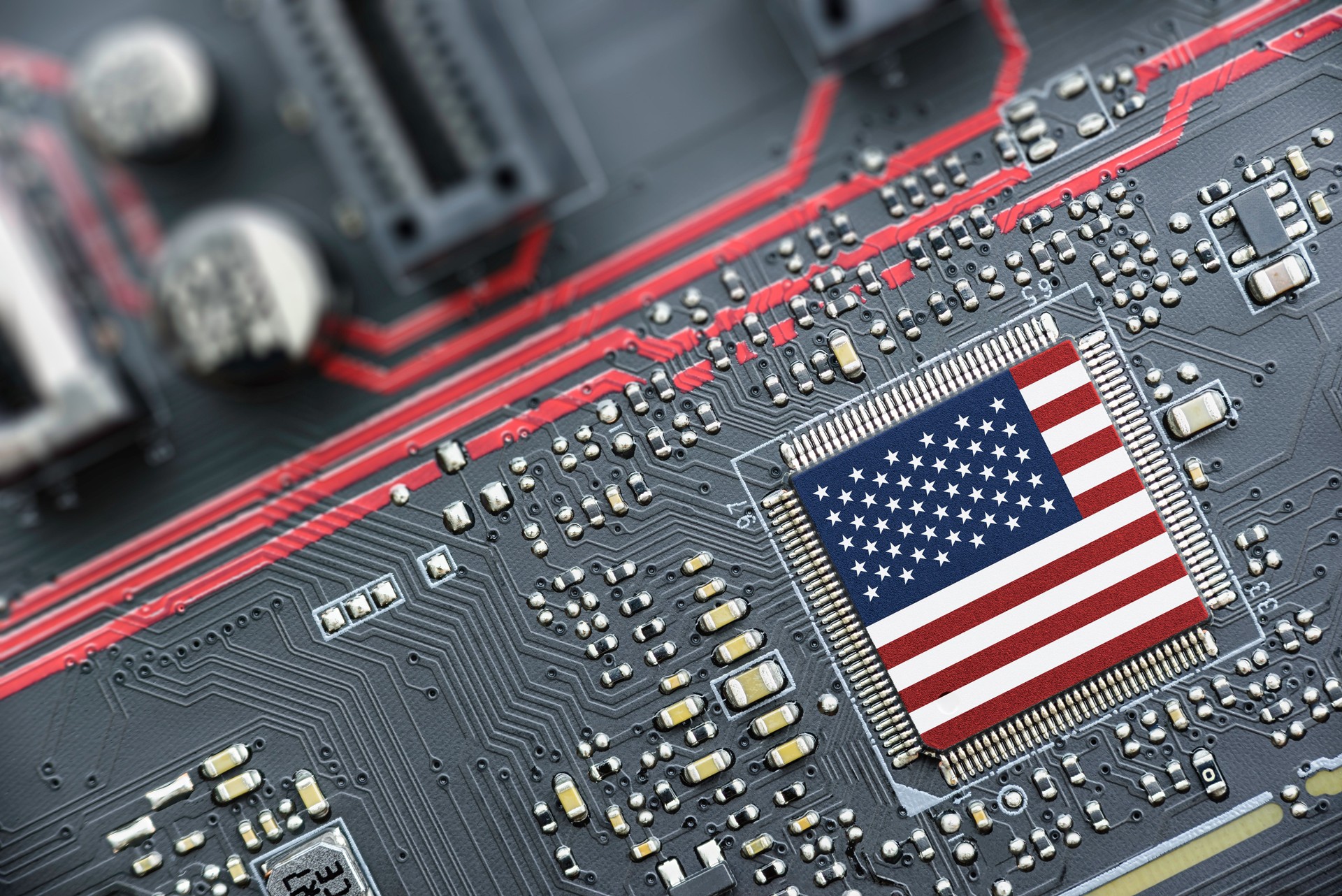 Flag of USA on a processor, CPU Central processing Unit or GPU microchip on a motherboard. Congress passes the CHIPS Act of 2022 to strengthen domestic semiconductor manufacturing, research and design